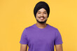 © ViDi Studio - Smiling cheerful fun happy devotee Sikh Indian man ties his traditional turban dastar wear purple t-shirt looking camera isolated on plain yellow background studio portrait. People lifestyle concept.