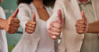 © Simamkele K/peopleimages.com - Business people, hands and thumbs up for good job, winning or yes in agreement at the office. Group of employee workers showing hand sign or emoji in team support for like, agree or yes at workplace