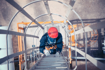 Wall Mural - Male climb the ladder tank