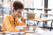 © David - Attractive african young confident businesswoman Accounting using calculating income-expenditure and analyzing real estate investment data report Financial and tax systems concept.
