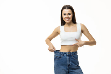 Wall Mural - beautiful young woman with big jeans, isolated on white background