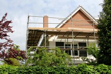 Outside Renovation Of Residential House And Scaffold Tower