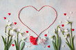 Decorative background with flowers of snowdrops, with red and white hearts, a symbol of the holiday on March 1 martenitsa, Martisor, Baba Marta, copy space.