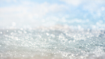 Abstract blurred blue sea water with bokeh defocused natural background or wallpaper with copy space.