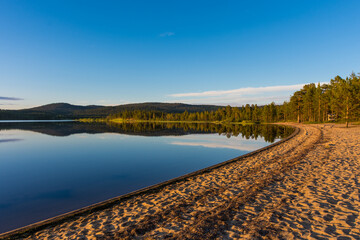 Wall Mural - Peaceful landscape of Lake Inari with the midnight sun in Lapland, Finland