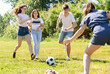 © JackF - Cheerful teen friends gaily spending time together on summer day, playing with ball outdoors