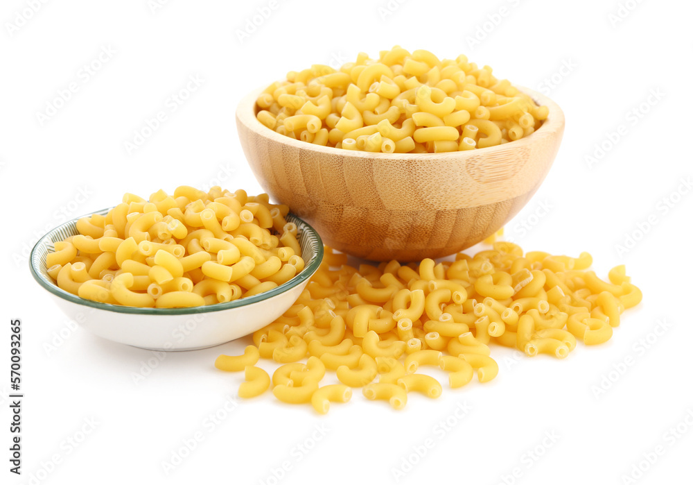 Bowls of uncooked elbow pasta isolated on white background