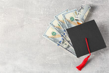 Scholarship concept. Graduation cap and banknotes on light grey table, flat lay with space for text