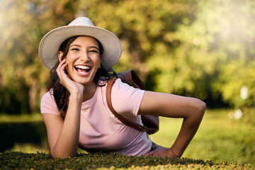 Wall Mural - Woman, portrait and park activity of a young person happy about nature, travel and freedom. Happiness, smile and laughing female with blurred background in a garden feeling relax and summer fun