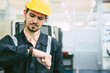 © Quality Stock Arts - engineer worker looking at wristwatch. industry factory working hours afternoon break times for lunch