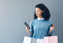 Mockup, Credit Card And Black Woman With Smartphone, Shopping Bags And Ecommerce On Grey Studio Background. African American Female Customer, Lady And Shopper With Cellphone, Boutique Items Or Retail