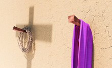 3D Rendering Of Crown Of Thorns And Purple Robe Hanging On Nails