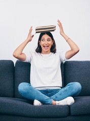 Canvas Print - Student or woman with books balance on head for study, education or university time management and reading. Knowledge, learning and young college person on sofa with history, philosophy or literature