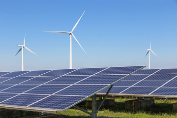 Wall Mural - solar cells with wind turbines generating electricity in hybrid power plant systems station on blue sky background 