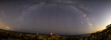 Milkyway Panorama Along The Rocky Coastline With Lighthouses Below.