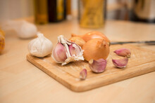 Onion And Garlic On Chopping Board