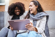 © Kirsten D/peopleimages.com - City women, laughing or bonding on tablet at funny joke, meme or comic internet news on relax urban street. Smile, happy or fashion friends on technology for travel planning or trendy style research