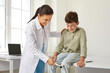 © Studio Romantic - Friendly, smiling doctor examining a happy child. Professional neurologist using a medical hammer to check the knee jerk patellar reflex of a little school boy. Neurology, health checkup concept