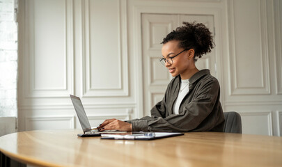 A young female freelance designer working in an office using a desktop computer. Office worker is a daily job.