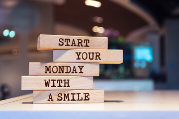 wooden blocks with words 'start your monday with a smile'.