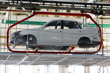 Wall Mural - Car body transported by hanging conveyor in plant workshop