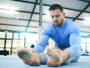 Canvas Print - Gymnastics, exercise or man stretching legs in gym before training, workout or health wellness. Focus, serious fitness or sport athlete doing pilates, meditation or zen balance in sports studio floor