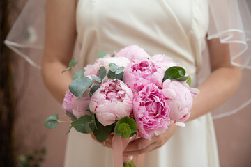 Wall Mural - Bride's bouquet in the hands of the bride