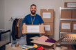 © Zamrznuti tonovi - Portrait of a man volunteer working in a charity donation center