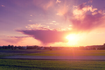 Wall Mural - sunset in the countryside. dramatic sky over the farmland