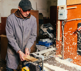 Wall Mural - Work on woodworking machines and saws in a furniture workshop