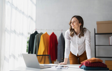 Portrait of young beautiful asian woman fashion designer stylish stand and working with color samples.Attractive young asian girl working with colorful fabrics at fashion studio