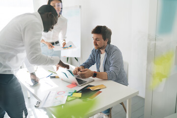 Sticker - Focused diverse colleagues working on project in office