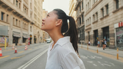 Wall Mural - Young woman crossing the road at crosswalk