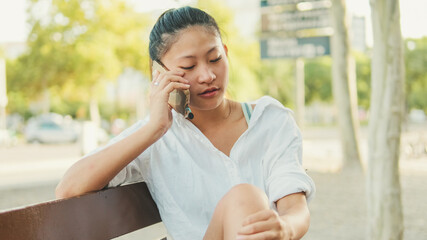 Wall Mural - Close-up of young woman talking on cell phone