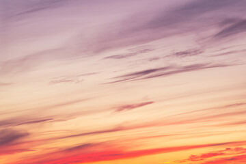 Wall Mural - Sky with soft and fluffy pastel orange pink and blue colored clouds. Sunset background. Nature. sunrise. Instagram toned style