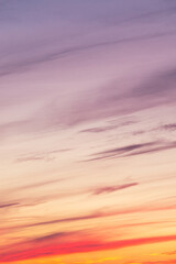 Wall Mural - Sky with soft and fluffy pastel pink and blue colored clouds. Sunset background. Nature. sunrise. Instagram toned style. Vertical
