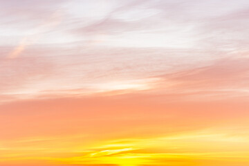 Wall Mural - Sky with soft and fluffy pastel orange pink and blue colored clouds. Sunset background. Nature. sunrise. Instagram toned style
