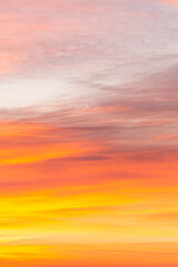 Wall Mural - Sky with soft and fluffy pastel orange pink and blue colored clouds. Sunset background. Nature. sunrise. Instagram toned style. Vertical