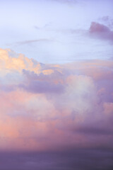 Wall Mural - Sky with soft and fluffy pastel lilac pink and blue colored clouds. Sunset background. Nature. sunrise. Instagram toned style. Vertical