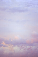 Wall Mural - Sky with soft and fluffy pastel lilac pink and blue colored clouds. Sunset background. Nature. sunrise. Instagram toned style. Vertical