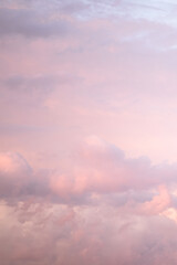 Wall Mural - Sky with soft and fluffy pastel pink and blue colored clouds. Sunset background. Nature. sunrise. Instagram toned style. Vertical