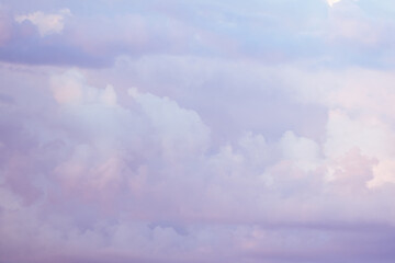 Wall Mural - Sky with soft and fluffy pastel pink and blue colored clouds. Sunset background. Nature. sunrise. Instagram toned style