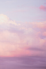  Sky with soft and fluffy pastel pink and blue colored clouds. Sunset background. Nature. sunrise. Instagram toned style. Vertical