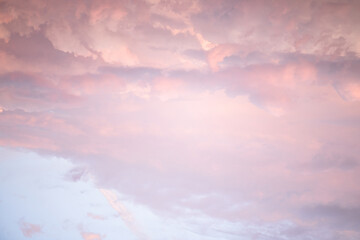 Wall Mural - Sky with soft and fluffy pastel pink and blue colored clouds. Sunset background. Nature. sunrise. Instagram toned style