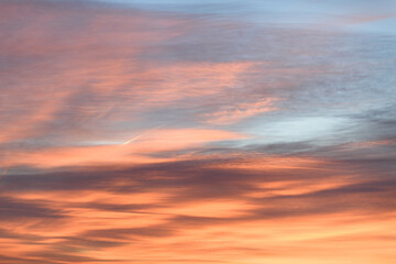 Wall Mural - Sky with soft and fluffy pastel orange pink and blue colored clouds. Sunset background. Nature. sunrise. Instagram toned style