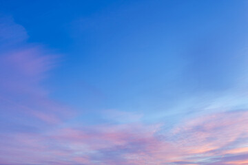 Wall Mural - Sky with soft and fluffy pastel pink and blue colored clouds. Sunset background. Nature. sunrise. Instagram toned style
