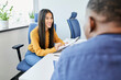 © baranq - Young woman talking with colleague in the office during casual work meeting