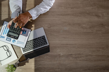 Wall Mural - businessman using a calculator top view, calculating user expenses, budgeting, and loan accounting 