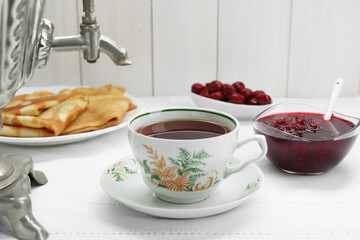 Wall Mural - Cup of aromatic tea and treats on table