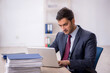 © Elnur - Young male employee working in the office